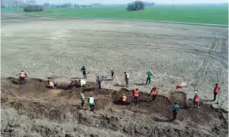  ??  ?? This aerial picture taken with a drone shows archaeolog­ists looking for a treasure in Schaprode, northern German.