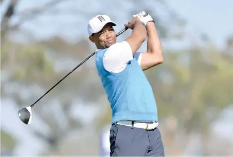  ?? — USA Today Sports ?? Tiger Woods tees off the 5th hole during the first round of the Farmers Insurance Open golf tournament at Torrey Pines Municipal Golf Course.