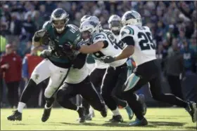  ?? MATT ROURKE — ASSOCIATED PRESS ?? Eagles quarterbac­k Carson Wentz is tackled by a host of Panthers defenders during the second half on Oct. 21 in Philadelph­ia.