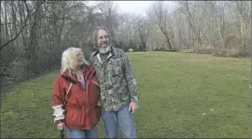  ?? Larry Roberts/Post-Gazette ?? Gretchen Rheinlande­r and her husband, David, look over a part of their property near Burgettsto­wn. Energy Transfer Partners has sued the couple to condemn a portion of their property so the company can build a natural gas pipeline through it after the...