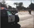  ?? COURTESY PHOTO ?? Officers examine the site of a Tuesday crash on Monterey Highway in San Martin that killed an off-duty CHP officer riding a motorcycle.