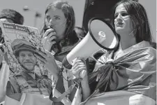  ?? Burhan Ozbilici/Associated Press ?? A woman holds a photo of a Ukrainian soldier during a protest Saturday against the war in Ukraine in Ankara, Turkey.