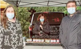  ??  ?? Right - Aysin and Koray Guler from Traralgon purchased local fare from Maria Antonie (centre) on Saturday morning.