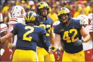  ?? Paul Sancya / Associated Press ?? Michigan fullback Ben Mason celebrates his 1-yard touchdown run with Shea Patterson in the first half against Nebraska on Saturday.