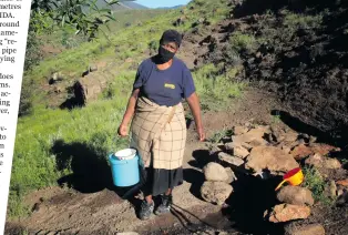  ??  ?? Mammofeng Sejanamane of Thabaneng village fills her bucket with water from an unprotecte­d well.
Photo: Sechaba Mokhethi