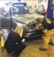  ?? National Transporta­tion Safety Board ?? Investigat­ors examine the Uber SUV that fatally struck a woman in Tempe, Ariz., on March 18.