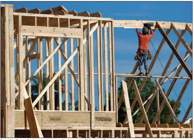  ?? (AP) ?? A constructi­on worker frames a house earlier this year in Richardson, Texas.