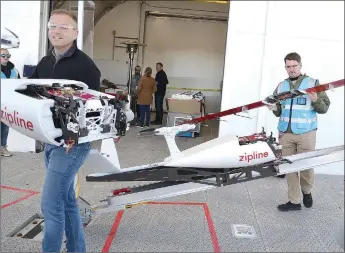  ?? TIMES photograph by Annette Beard ?? The drone mechanics are encased in styrofoam, aiding in the light weight of the drone. Liam O’Connor, chief operating officer of Zipline, shows off one of the drones.