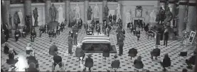  ?? AP-Olivier Douliery ?? A U.S. Capitol Police honor guard surrounds the flag-draped casket of Justice Ruth Bader Ginsburg as lies in state in Statuary Hall of the U.S. Capitol, on Friday in Washington.