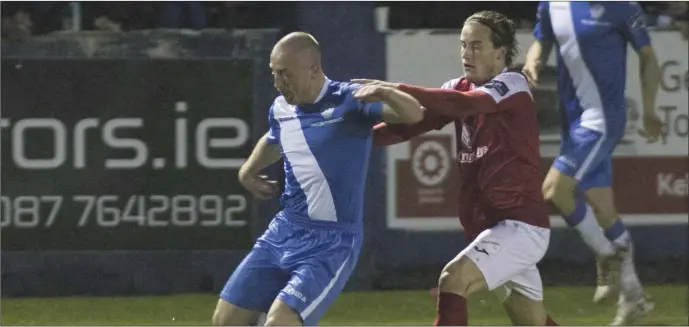  ??  ?? Rhys McCabe tussles with Finn Harps’ Tommy McBride. Pics: North West Newspix