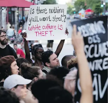  ?? ALLEN MCINNIS/POSTMEDIA NEWS ?? Protesters in Montreal demonstrat­e outside of the Jazz Festival show SLĀV, 'a theatrical odyssey based on slave songs,' which was created by and starred predominat­ely white artists, at the Theatre du nouveau monde on Tuesday.