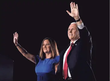  ?? DREW ANGERER / GETTY IMAGES ?? Mike Pence stands with his wife, Karen Pence, before accepting the vice presidenti­al nomination during the Republican National Convention on Wednesday.