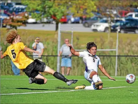  ?? PETE BANNAN — DIGITAL FIRST MEDIA ?? West Chester forward Doug Goitia slips the ball past Millersvil­le defender Nathan Maynard for the team’s second goal in the first half Wednesday.