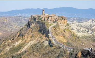  ??  ?? The Italian town of Civita di Bagnoregio is accessible only by a bridge.