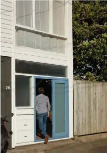  ??  ?? Above and right Moore-Jones enters the front door through the street façade. The stack of boxes to the left of the door includes a mailbox on top and two larger boxes for milk deliveries; one for the main house and one for the flat. Inside, the foyer is open to the garden and provides access to the flat upstairs.Left ‘Untitled’ (1967) by Gordon Walters hangs on a hidden cupboard wall designed by Plischke.