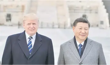 ?? — AFP photo ?? File photo shows Trump and Xi Jinping pose at the Forbidden City in Beijing.