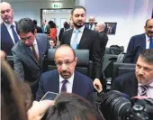  ?? Joe Klamar / AFP / Getty Images ?? Saudi Arabia Energy Minister Khalid al-Falih (center) speaks to journalist­s Thursday at the OPEC conference in Vienna.