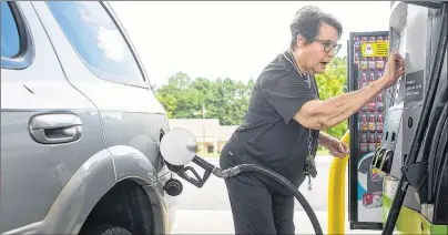  ?? CHELSEA PURGAHN/TYLER MORNING TELEGRAPH VIA AP ?? Dollie Chase inserts her card to pay for gas at a Walmart in Tyler, Texas, on Thursday. It’s getting harder to fill gas tanks in parts of Texas where some stations are out of fuel and pump costs are spiking in the aftermath of Harvey.