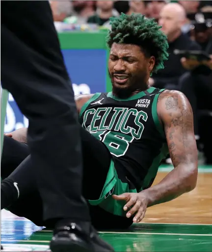  ?? STAFF PHOTO BY NANCY LANE/ MEDIANEWS GROUP/ BOSTON HERALD ?? Celtics guard Marcus Smart winces as he was knocked to the floor during the third quarter of Game 1 of their second-round playoff series at the TD Garden on Sunday.
