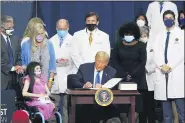  ?? CHRIS CARLSON - THE ASSOCIATED PRESS ?? President Donald Trump signs an executive order after delivering remarks on healthcare at Charlotte Douglas Internatio­nal Airport, Thursday, Sept. 24, in Charlotte, N.C.