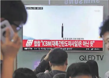  ??  ?? People watch a TV news program showing a file image of a missile launch conducted by North Korea on May 21, at the Seoul Railway Station in Seoul, South Korea. With North Korea’s nuclear missile threat in mind, the Pentagon is planning a missile...