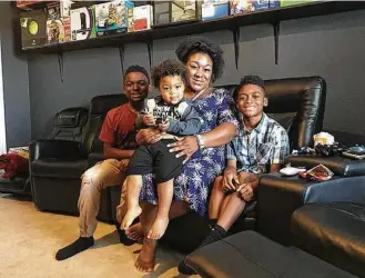  ?? Lauren Silverman / KERA via Tribune News Service ?? Jessica Chester, with her three children, from left, Ivory, Kameron and Skylar, got a degree and works for a Dallas hospital doing community outreach and family planning.