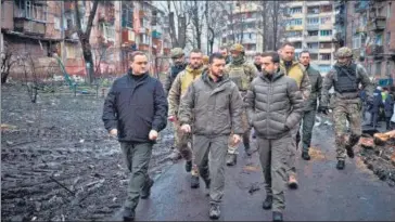  ?? AFP ?? Volodymyr Zelensky (centre) inspects damaged residentia­l buildings in Vyshgorod, outside of Kyiv, on Friday.