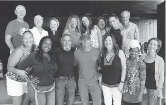  ?? JILL TRUNNELL/FOR THE ASSOCIATED PRESS ?? Kenny Chesney, centre, seen with residents from St. John in the U.S. Virgin Islands, is donating proceeds from the sale of his new album to hurricane recovery efforts.