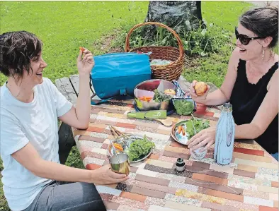  ?? VERN BASTABLE/SPECIAL TO THE EXAMINER ?? GreenUP staff enjoy a picnic at Ecology Park in Peterborou­gh using waste-free, reusable alternativ­es to disposable, single-use food packing options.