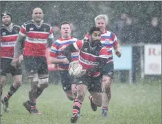  ??  ?? Wicklow RFC’s Billy Ngawini looks to set a colleague on their way.