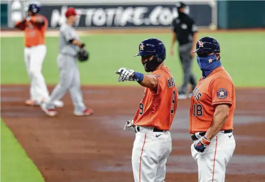  ?? Karen Warren / Staff photograph­er ?? Jack Mayfield points the way to victory in the first game of Tuesday’s doublehead­er after singling home Kyle Tucker and Josh Reddick as part of the Astros’ five-run first inning in their 6-3 victory.