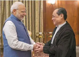  ?? — PTI ?? Prime Minister Narendra Modi greets the Chief Justice of India Justice Ranjan Gogoi after he was administer­ed the oath of office at Rashtrapat­i Bhavan in New Delhi on Wednesday.