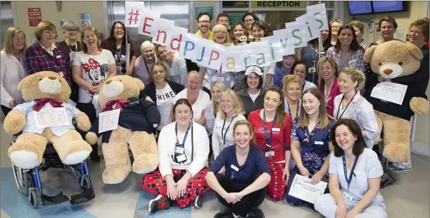  ??  ?? St Columchill­e’s Hospital staff in their pyjamas to show support for the ‘End PJ Paralysis’ campaign.