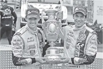  ??  ?? French world champion rally driver 2014 Sebastien Ogier (L) and his co-driver Julien Ingrassia (R) of Volkswagon Motorsport celebrate winning the 2014 Wales GB Rally in the final round of the FIA World Rally Championsh­ip in LLandudno,Wales. - AFP photo