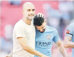  ?? — Reuters photo ?? Manchester City manager Pep Guardiola celebrates with Sergio Aguero after winning the Community Shield against Chelsea at the Wembley Stadium.