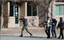  ?? Steve Marcus/Las Vegas Sun via AP ?? Law enforcemen­t officers head toward the University of Nevada, Las Vegas, campus, Wednesday after reports of an active shooter. Three people were killed, police said.