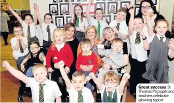  ??  ?? Great success St Thomas PS pupils and teachers celebrate glowing report