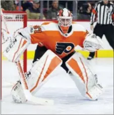  ?? CHRIS SZAGOLA — THE ASSOCIATED PRESS ?? Flyers goalie Brian Elliott, here covering a shooting angle Thursday night against the Sabres, overcame a behindthe-net boo-boo that resulted in Buffalo’s first goal.