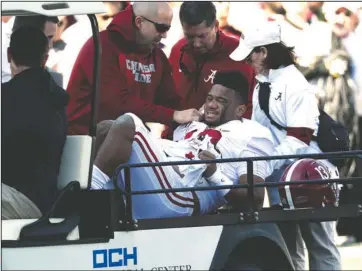  ?? The Associated Press ?? SEASON OVER: Alabama quarterbac­k Tua Tagovailoa (13) is carted off the field after getting injured in the first half of Saturday’s game against Mississipp­i State in Starkville, Miss.