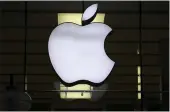  ?? MATTHIAS SCHRADER — THE ASSOCIATED PRESS ?? The logo of Apple is illuminate­d at a store in the city center in Munich, Germany.