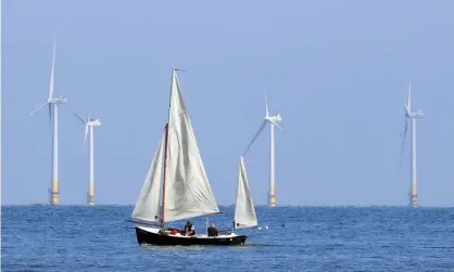  ?? Photograph: Gareth Fuller/PA ?? A sailing boat passes the Kentish Flats offshore windfarm.