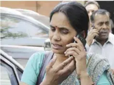  ??  ?? NEW DELHI: Asha Devi and Badri Singh, mother and father respective­ly, of the victim of the fatal 2012 gang rape on a moving bus, speak on their mobile phones as they arrive at the Supreme Court complex yesterday. — AP