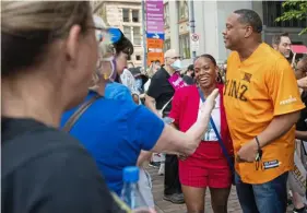  ?? Emily Matthews/Post-Gazette ?? Summer Lee and Ed Gainey talk to people in the crowd during Pittsburgh’s Bans Off Our Bodies rally earlier this year outside the City-County Building Downtown.