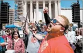  ?? SCOTT HEINS/GETTY ?? Edward Hudson leads music teachers from across Oklahoma in a Wednesday pep rally outside the state Capitol.