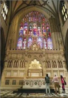  ?? KATHY WILLENS — THE ASSOCIATED PRESS ?? In this photo, visitors to Trinity Church look at stone carvings in the chancel of the 19th century Gothic Revival style church in New York. New York’s historic Trinity Church will be largely closed to visitors during a twoyear renovation. The current...