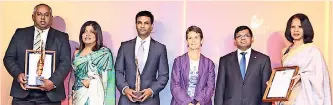  ??  ?? Group CEO Gahanath Pandithage of DIMO (Overall Runner Up) and Head of Sustainabi­lity Isuru Gunasekera and Head of Legal & HR Dilani Alagaratna­m of JKH (Overall Winner) with presentati­on party