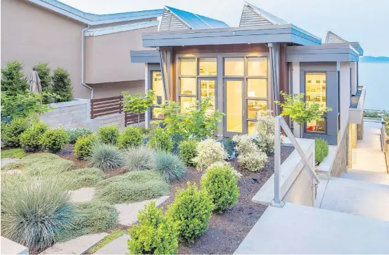  ?? GEOFF HOBSON PHOTOS ?? Christophe­r Walker of Christophe­r Developmen­ts designed and built the Cordova Bay house. The drought-tolerant garden is by Zenith Developmen­ts Landscapin­g.