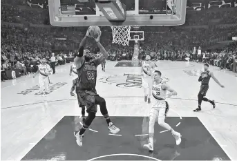  ??  ?? Los Angeles Lakers forward LeBron James dunks the ball as Portland Trail Blazers forward Zach Collins defends in the second quarter of their NBA game at Staples Center in Los Angeles on Wednesday. The Lakers won 126-117. — Reuters