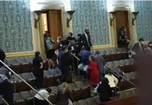  ?? Getty iMages FiLe ?? DOUBLE TROUBLE: Members of Congress evacuate the House Chamber as protesters attempt to enter on Wednesday in Washington, D.C. Doctors are saying those who sheltered in place in another room may have been exposed to someone with the coronaviru­s.