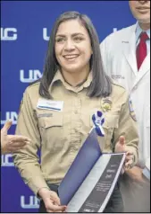  ?? Elizabeth Page Brumley Las Vegas Review-Journal ?? Miranda Smith, paramedic with MedicWest, receives a certificat­e of appreciati­on during a University Medical Center luncheon.